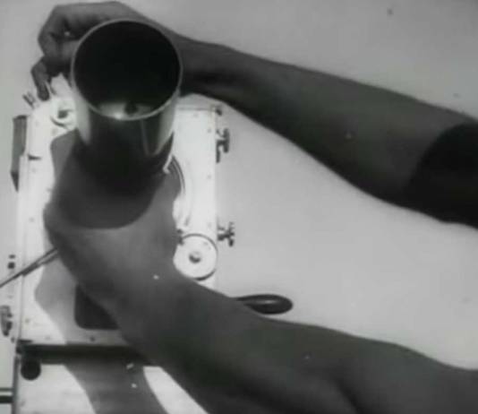 Scene from "Man with a Movie Camera" (1929) Hands adjusting a camera