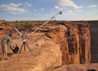Risk-taking cameraman filming from the top of a very high cliff in the canyons of Utah