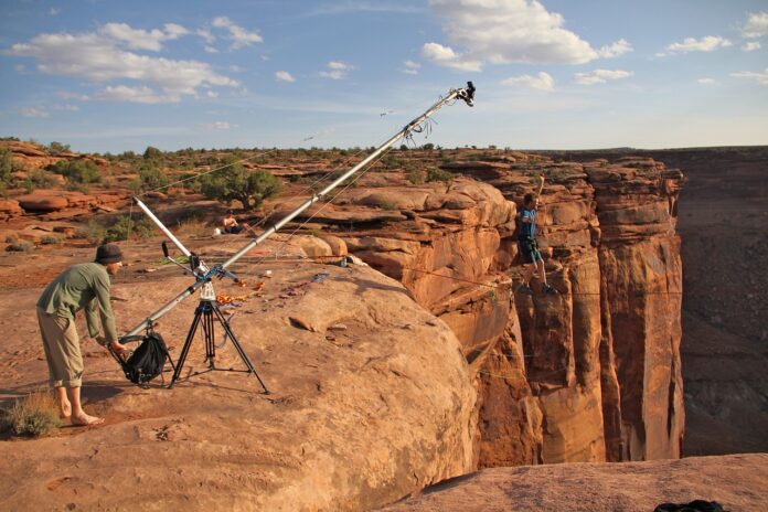 Risk-taking cameraman filming from the top of a very high cliff in the canyons of Utah