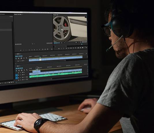 Editor working in Premiere Pro on computer