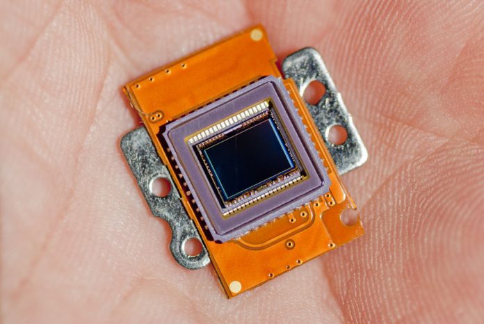 Photo of an image sensor in the palm of a hand